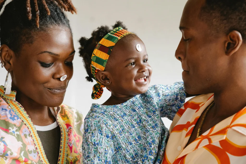 African parents with young daughter during family photography session in Cambridge UK