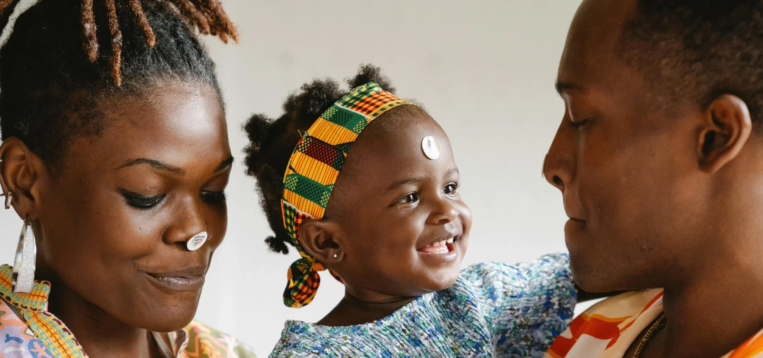 African parents with young daughter during family photography session in Cambridge UK
