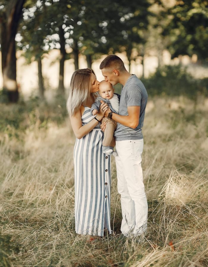Family with cute little son. Father in a gray shirt. Lady in a dress