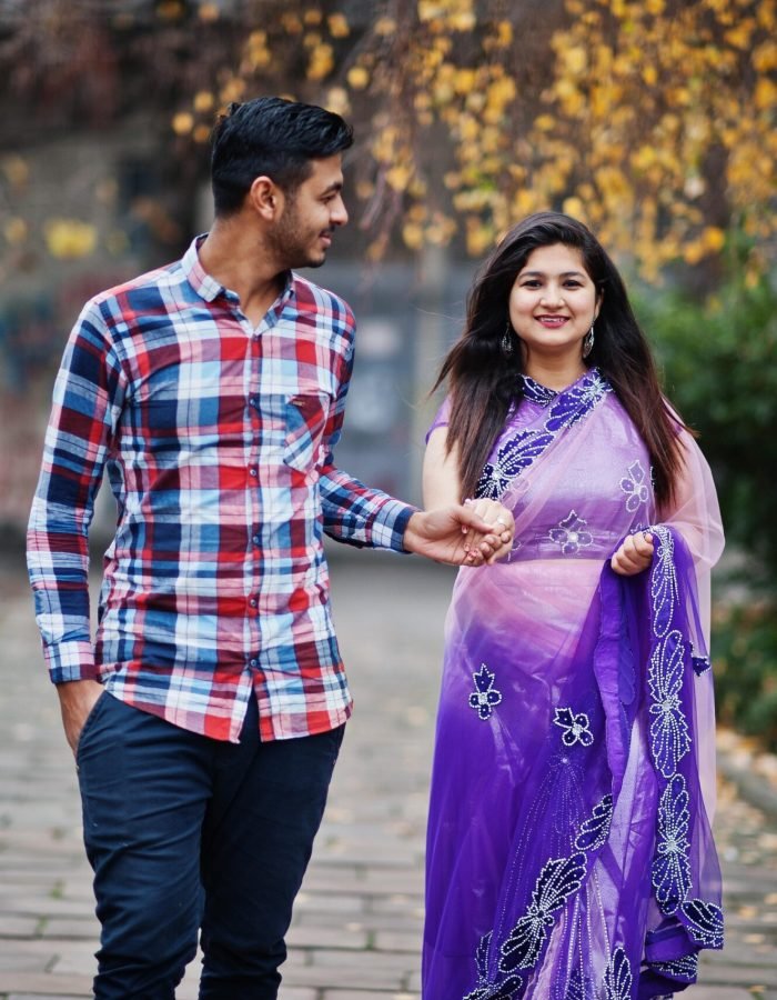 Stylish indian hindu couple posed on street.